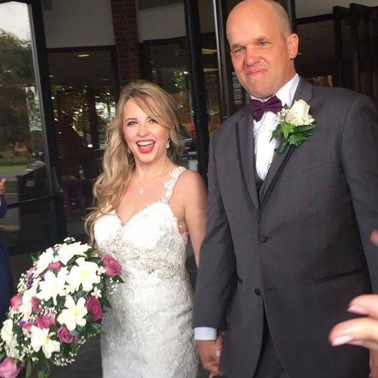 Heather and Christopher Dempsey smile for the cameras on their wedding day