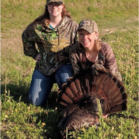 Kristen Black (left) with a turkey