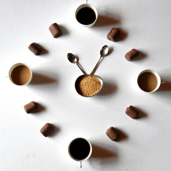 Clock made of coffee cups and rolls