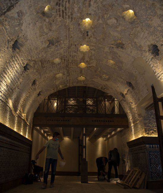 Workers examine a 12th Century bathhouse