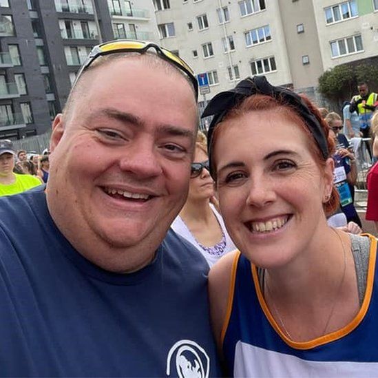 Peter Byrom and Natalie le Grange (right) smiling at the camera after running the Bristol 10k in 2021 for Sands