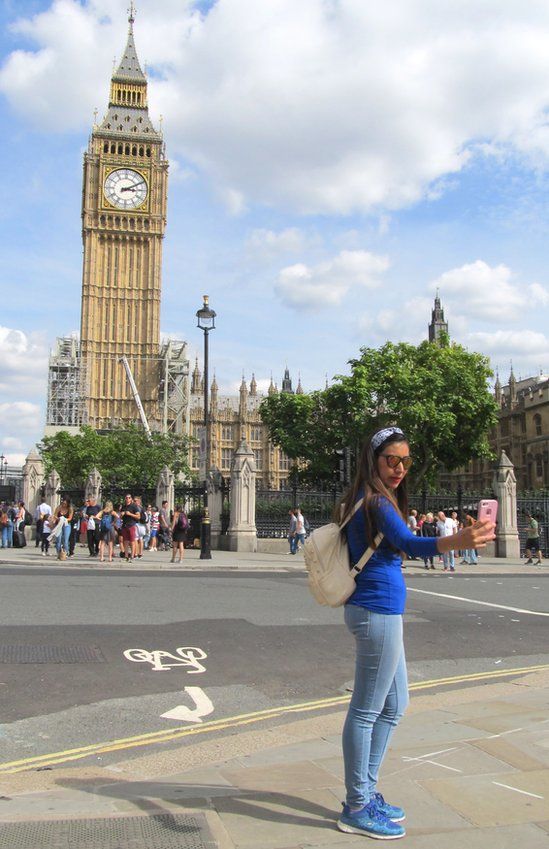 A woman taking a selfie in front of Big Ben