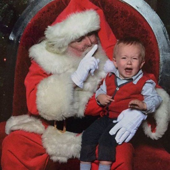 Child crying on Santa's lap