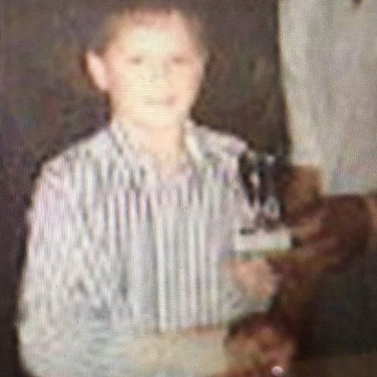 Young Jamie Perkins with a sports trophy