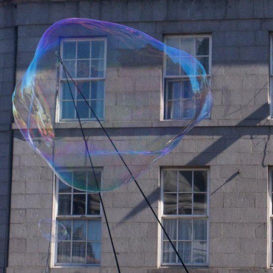 Giant bubble in front of a building