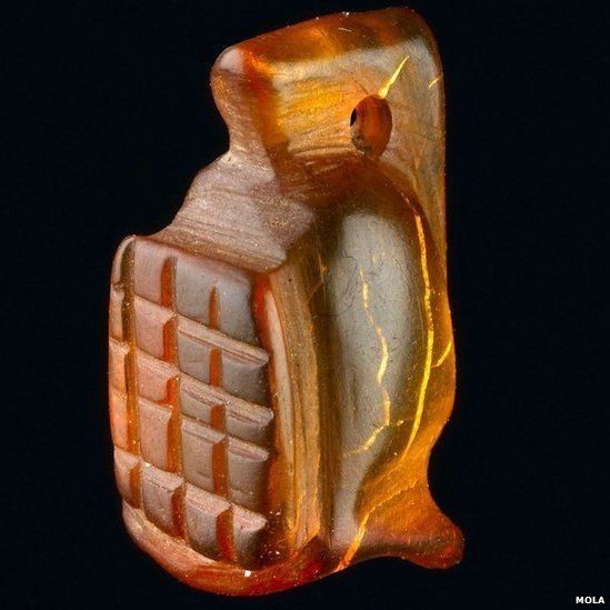 Amber amulet in the shape of a gladiator’s helmet