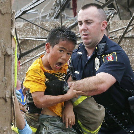 A boy is pulled from the wreckage of Plaza Towers Elementary School in Moore