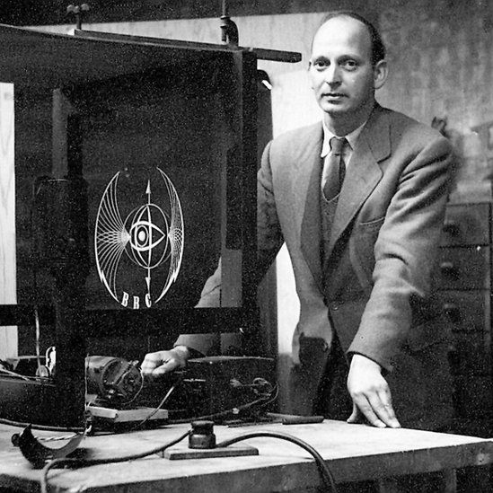 Abram Games with a model he made to film the TV logo he designed for the BBC
