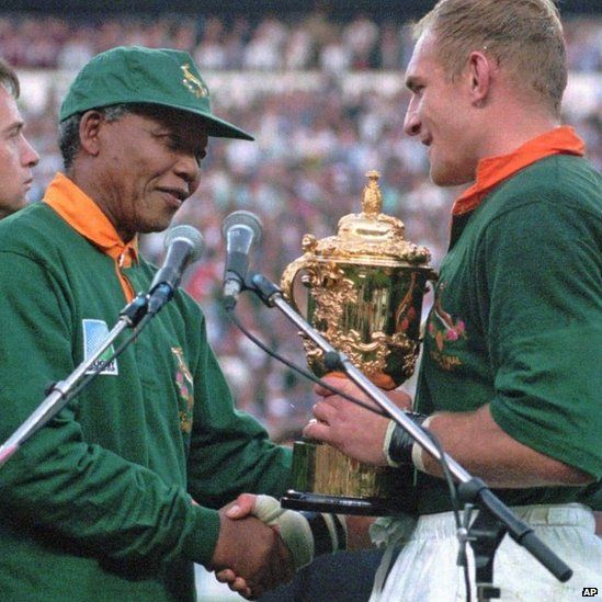 24 June 1995: South African rugby captain Francios Pienaar receives the Rugby World Cup from South African President Nelson Mandela