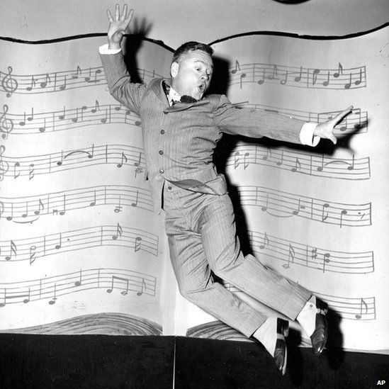 In this 1957 file photo, Mickey Rooney, wearing spats and a pinstriped suit, performs a dance routine during rehearsal for the television show George M Cohan Story in Hollywood