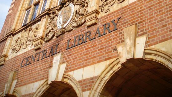 The oustide of Wolverhampton Central Library, showing the Central Library sign above arches on a red brick wall