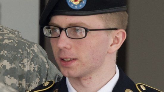 US Army PFC Bradley Manning is escorted by military police as he departs the courtroom at Fort Meade, Maryland 25 April, 2012