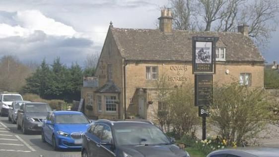 The Coach and Horses near Bourton-on-the-Water, with a queue of traffic going past