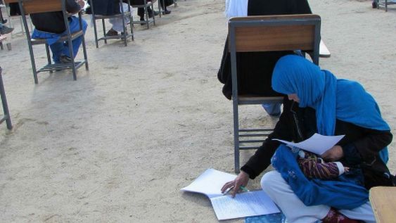 Jahan Taab taking her university exam whilst caring for her child