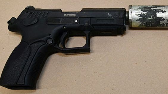 A semi-automatic handgun fitted with a silencer