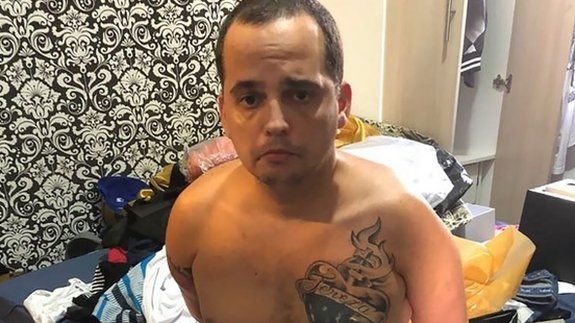 Handout picture released by Rio de Janeiro"s Civil Police showing Stephan de Souza Vieira, aka BH, a drug dealer that escaped from Aparecida de Goiania Prison Complex in November 2017, sitting on a bed after his re-arrest in Cabo Frio municipality, Rio de Janeiro State, Brazil, on January 7, 2018.