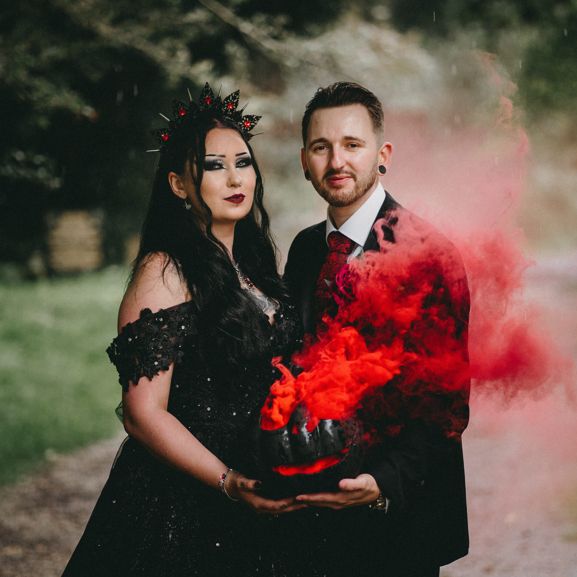 Hannah and Mathew pose in their wedding outfits