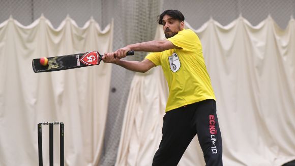 Somebody playing cricket at an event run by charities and police