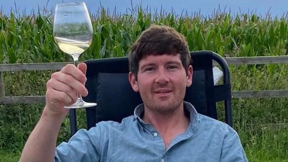 James Waterhouse raising a glass of wine
