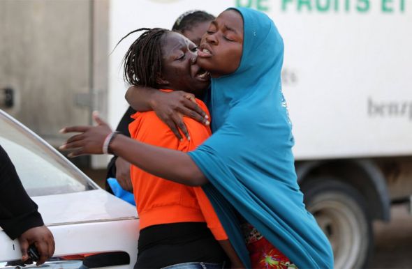 A migrant, who was not allowed to return to her country with other migrants for not having complete documents, cries as she is comforted at a detention center inTripoli, Libya, August 29, 2017.