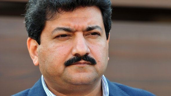 Pakistani journalist and television anchor, Hamid Mir talks with media representatives outside his home in Islamabad on November 26, 2012.