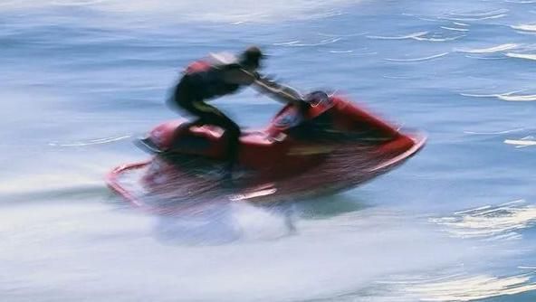 Two jet skiers travelling at high speed in the water. It is a stock image and not unique to this story.