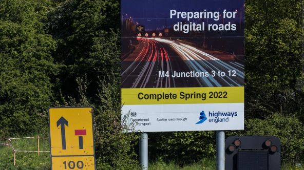 A sign announcing works by Highways England to convert the M4 into a "smart motorway" close to Junction 5, pictured in April 2021