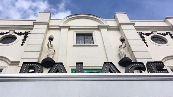 The front of the historic art deco cinema called palace in Devizes. The building is white with the word Palace written in black letters