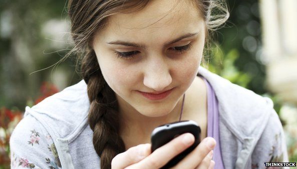 Young girl using mobile - posed by model