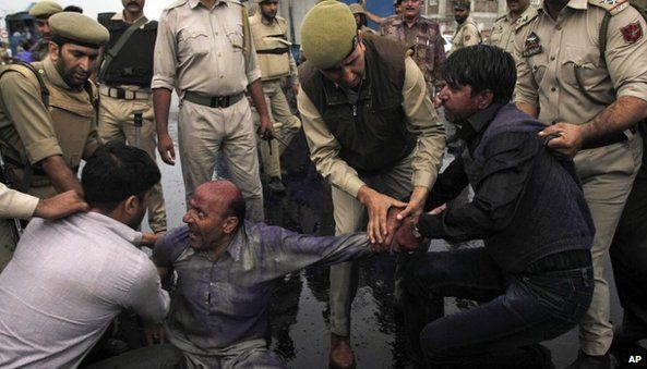 Indian policemen detain Kashmiri supporters of Awami Ittihad Party during a protest against a fatal paramilitary shooting in the disputed territory in Srinagar, India, Thursday, Sept. 12, 2013.