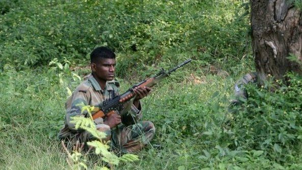 An Indian army soldier rests in undergrowth during an attack by militants on an army camp at Mesar in Samba District, some 20kms south-east of Jammu on September 26, 2013.