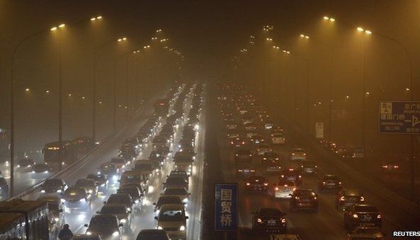 Vehicles drive on the Third Ring Road on a very hazy winter day in Beijing