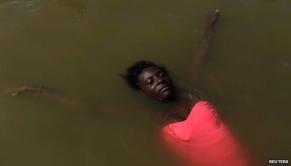 A girl relaxes in the Piscinao de Ramos artificial lake in Rio de Janeiro.