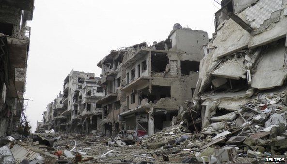 Damaged buildings along a deserted street in the besieged area of Homs (22 January 2014)