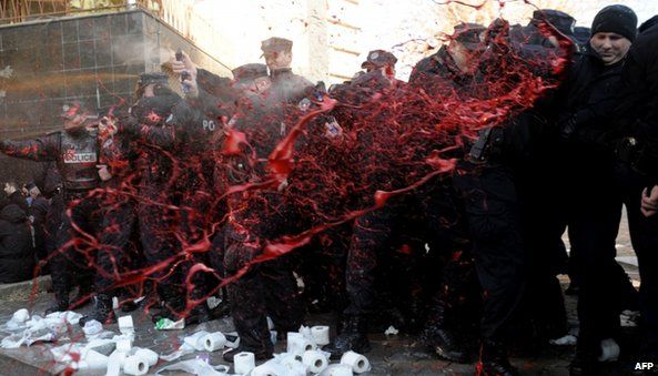 Protesters splash police officers with red paint at the Pristina protest (7 February 2014)