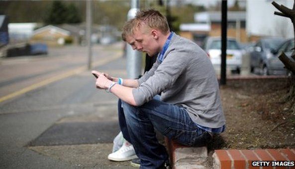 Two young men looking at their mobile phones