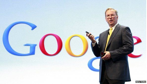 Eric Schmidt in front of Google logo