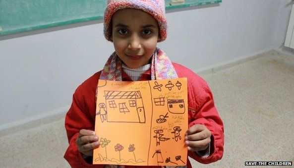 Siham, 10, with a picture of her house