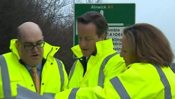 Prime minister David Cameron, centre, with Highways Agency staff in Northumberland