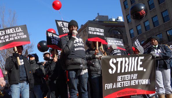 Fast food workers striking with signs