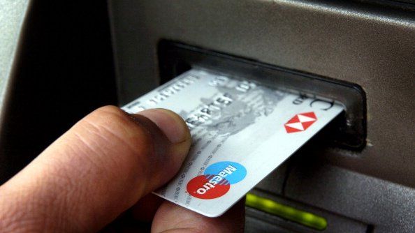 An HSBC Maestro debit card is being used in a cash machine
