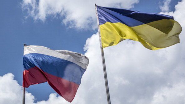 Flags of the Russian Federation, left, and Ukraine, fly side by side from flagpoles in Kiev, Ukraine, on Thursday, May 29, 2014. R