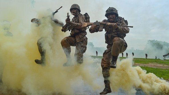 Indian Army recruits shout and jump next to colourful smoke during a training demonstration at the Jak Rifles regimental centre in Jabalpur in Madhya Pradesh state on August 9, 2019