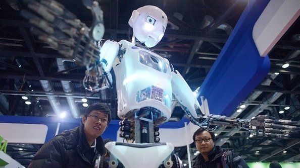China-science-computer-robot, by Ben DOOLEY This picture taken on November 24, 2015 shows visitors watching a robot (C) demonstration during the World Robot Conference in Beijing.