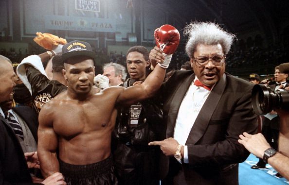 Mike Tyson celebrates with Don King after winning the fight against Alex Stewart, in 1990.