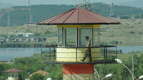 A guard walks on a watchtower of the Gldani prison, the site of recent jail abuse scandal in Tbilisi in September 2012