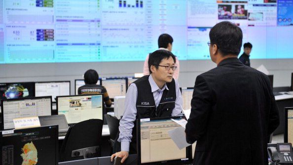 File photo: Members of the Korea Internet Security Agency check on cyber attacks at a briefing room of KISA in Seoul on 20 March 2013
