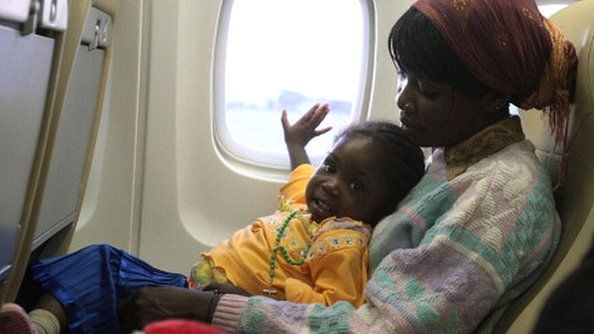 An Eritrean woman and child aboard an aeroplane