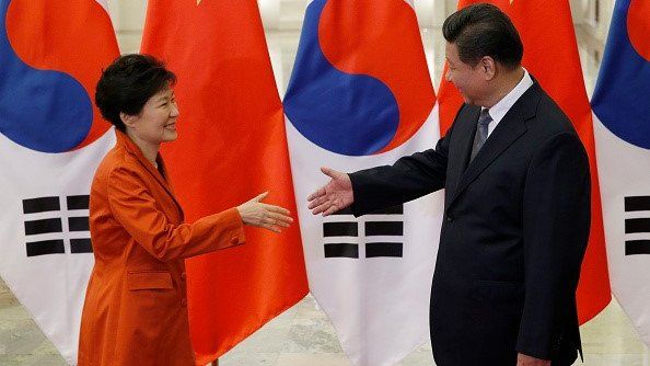China's President Xi Jinping (right) shakes hands with South Korea's President Park Geun-hye in Beijing