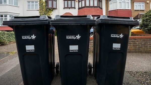 3 black wheelie bins